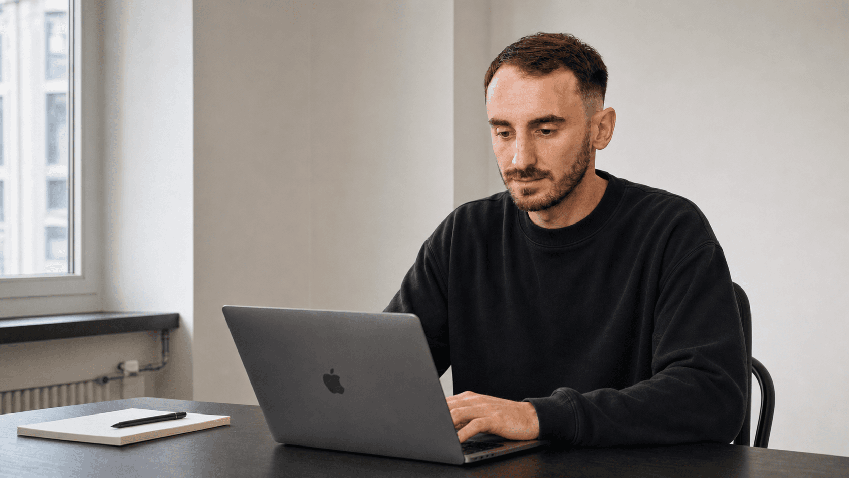 Branko reviewing CRM data quality work at a laptop
